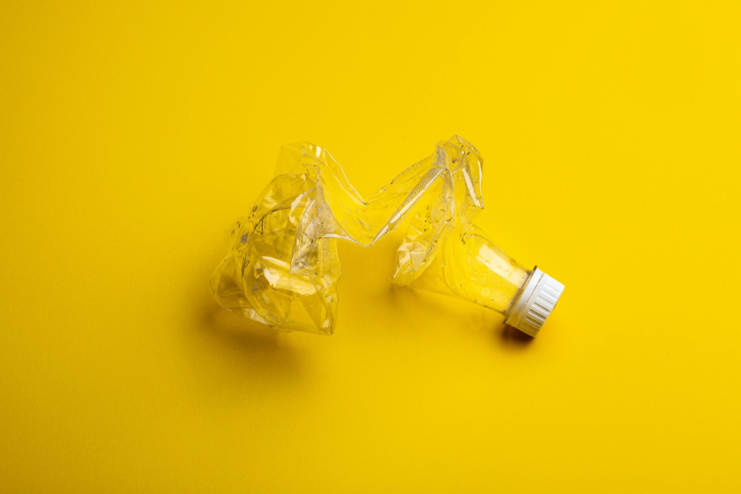 Plastic bottles on yellow background